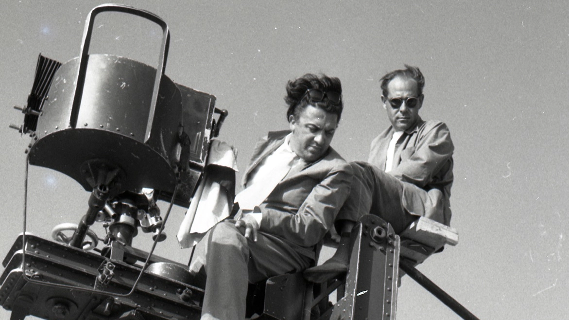 Uno dei manifesti del centenario: Fellini sul set de "La strada" (foto Mauro Penzo)