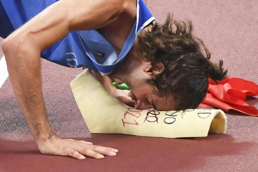 Gianmarco Tamberi of Italy celebrates as he share with Mutaz Essa Barshim of Qatar (not pictured) the first place and gold medal in the Men's High Jump Final during the Athletics events of the Tokyo 2020 Olympic Games at the Olympic Stadium in Tokyo, Japan, 01 August 2021.   ANSA / CIRO FUSCO