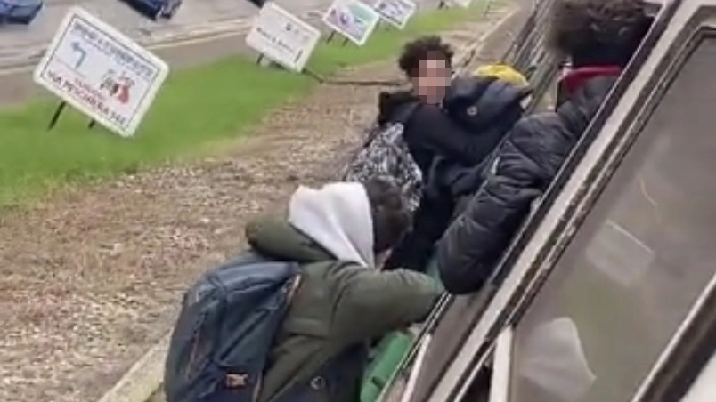 Un fermo immagine del video con i ragazzi appesi fuori dal treno