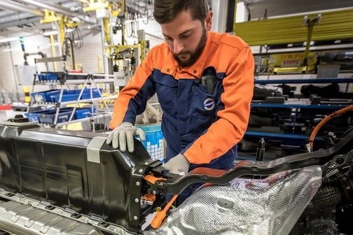 Operaio al lavoro in uno stabilimento che produce batterie al litio per auto
