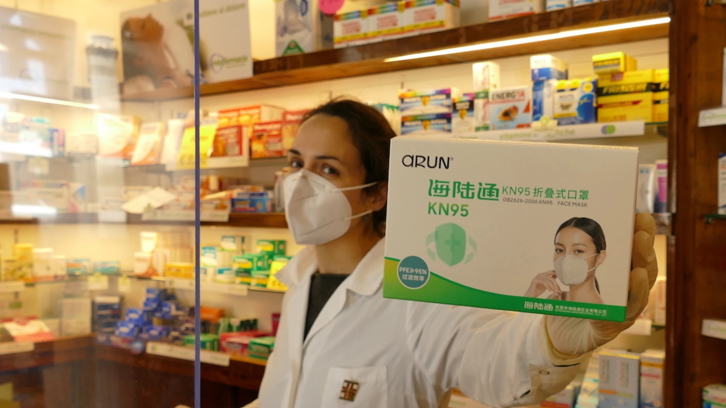Una farmacista mostra le confezioni di mascherine d’importazione (foto d’archivio)