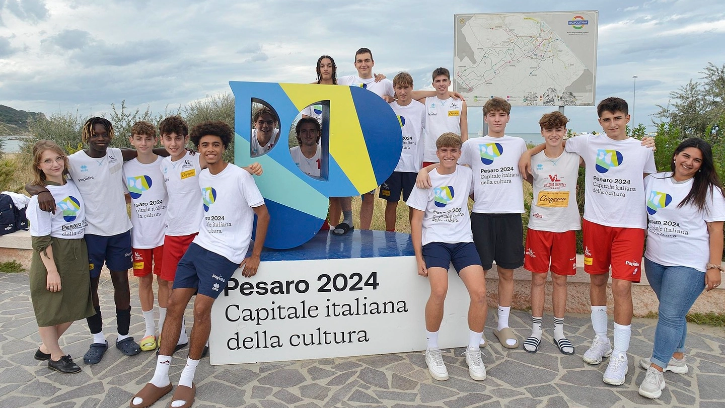 Un gruppo  di ragazzi attorno  al ‘totem’ di Pesaro 2024