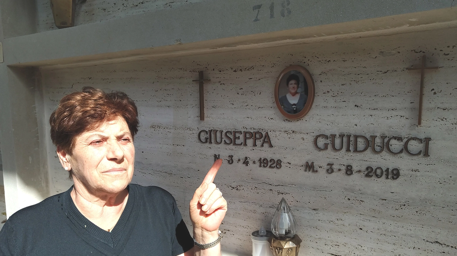Sandra Dominici davanti alla tomba con la sua foto