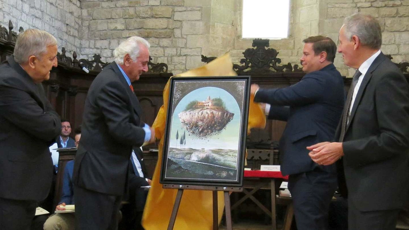 Mario Logli, secondo da sinistra, presenta il suo dipinto su Montefiorentino