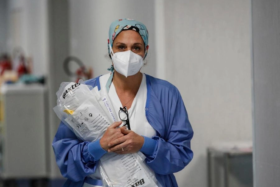 Un'operatrice sanitaria con la mascherina in ospedale (Ansa)
