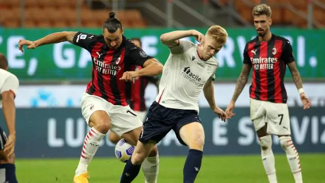AC Milan�s Zlatan Ibrahimovic (L) challenges for the ball  Bologna�s Jerdy Schouten during the Italian serie A soccer match  Ac Milan vs Fc Bologna  at Giuseppe Meazza stadium in Milan 21 September  2020.
ANSA / MATTEO BAZZI