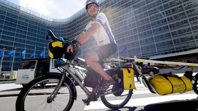 epa09276040 A participant sits on his bike at the start  of of the Sun Trip, a tour of Europe by electrical solar bike, in front of European Commission headquarters in Brussels, Belgium, 16 June 2021. Sun Trip is a tour of Europe by Electrical bikes charged by solar Panel. Some 50 amateur cyclists take part in the race which will stop in more than 33 European countries and will run 10, 000 km from June to September 2021.  EPA/OLIVIER HOSLET