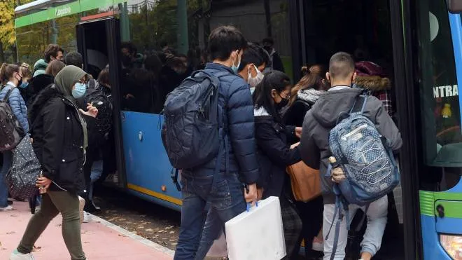 Alcuni pendolari mentre salgono sull’autobus