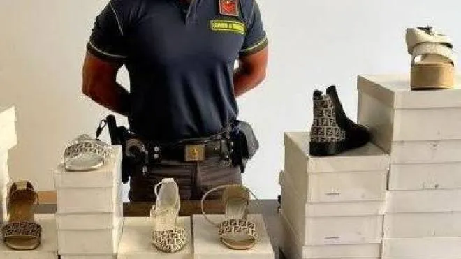 La foto della Guardia di Finanza con scarpe e ciabatte griffate Fendi e Gucci, sequestrate a Civitanova durante il mercato
