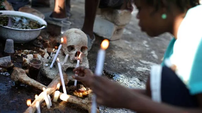 A voodoo believer makes offerings during celebrations at the cemetery of Port-au-Prince, Haiti, November 1, 2017. REUTERS/Andres Martinez Casares     TPX IMAGES OF THE DAY