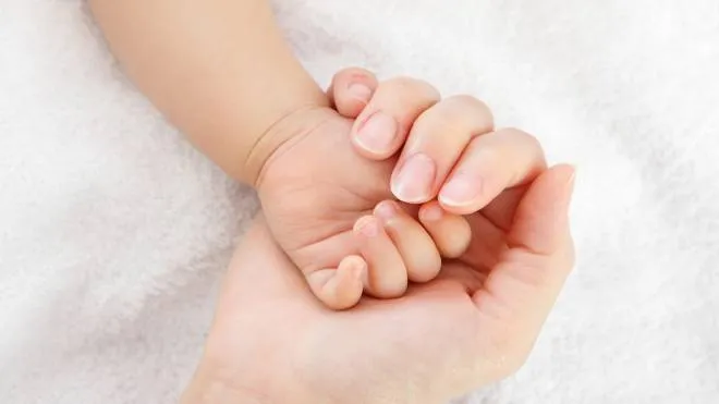 little baby hand with mother hand, close up, concept for love