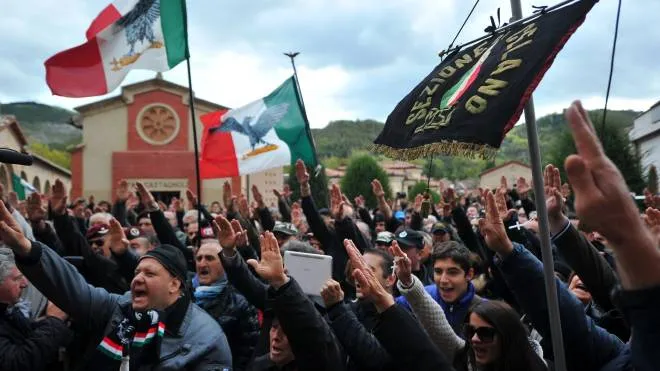 Far-right militants make the fascist salute during a rally marking the 90th anniversary of the "march on Rome" on October 28, 2012  in Predappio. The rally was organized in Predappio, where Italian fascit dictator Benito Mussolini was born and is buried, to mark the 90th anniversary of the "March on Rome", the beginning of his dictatorship.  AFP PHOTO / TIZIANA FABI
